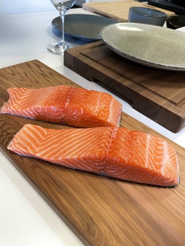 regal marlborough king salmon fresh fillets, presented on a wooden chopping board, before cooking